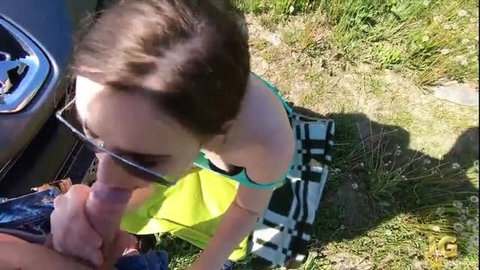 Brunette in sunglasses gives outdoor POV blowjob on grass