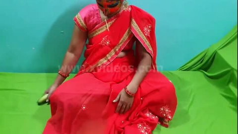 Desi bhabhi in red saree holding cucumber, outdoor adult scene