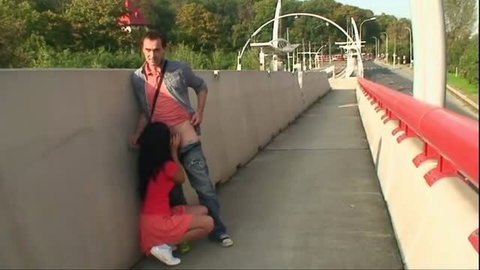 Amateur teen in red dress blows older man on public bridge