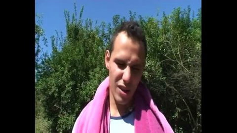 Man with pink towel around neck outdoors