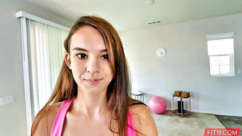 Cute fit teen Ellie Eilish smiling in pink sports bra