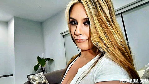 Blonde stepmom Lucy Doll in low-cut white tank top, seductive gaze