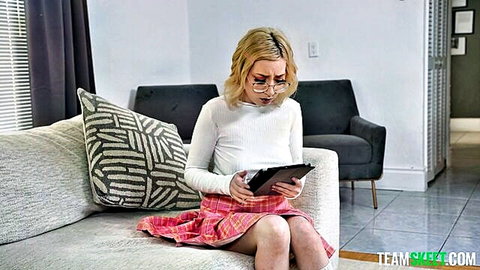 Prim Taylor as naughty student reading tablet in pink skirt and glasses