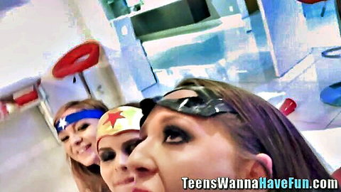 Three cosplay teens in Wonder Woman outfits posing seductively