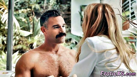 Shirtless muscular mustached hunk with hairy chest gazes at blonde babe in white blouse