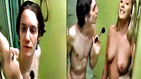 Shirtless guy teases busty blonde babe's exposed tits with makeup brush in bathroom