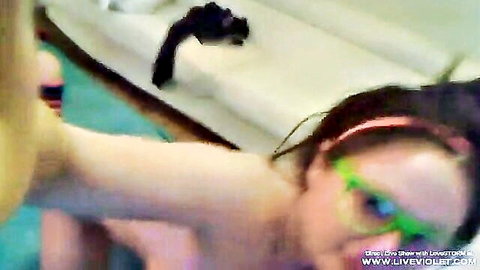 Lesbian babe with green glasses gets tight pussy fingered on couch during live cam show