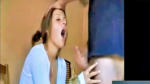 Brunette woman in white top giving intense blowjob with cumshot