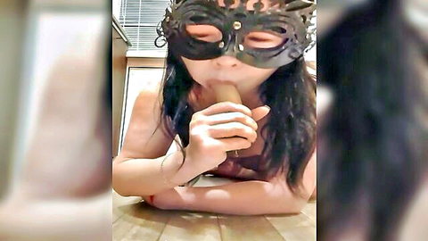 Masked Asian beauty sucking juicy dildo sensually