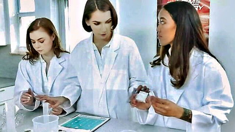 Three women in lab coats in chemistry lab, teasing before anal orgy after class