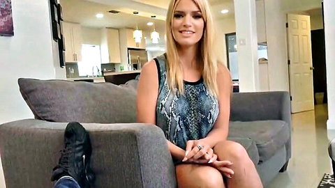 Blonde MILF in sexy snake-print tank top, legs crossed teasingly