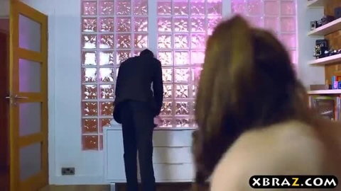 Lucia Love topless watching man by pink glass block window