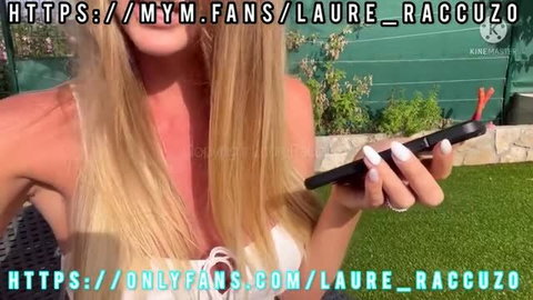 Laure Raccuzo in white bikini top, long blonde hair, holding phone outdoors