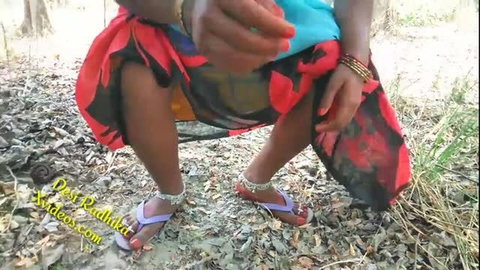 Indian woman in saree squatting outdoors for jungle sex