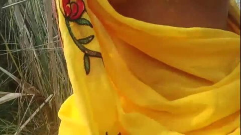 Indian bhabhi in yellow saree flashing outdoors in field