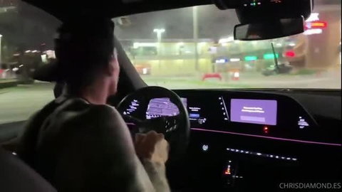 Man driving luxury car at night with digital dashboard display