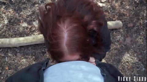 Redhead deepthroating thick cock outdoors in bushes