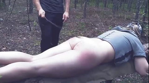 Wife bare bottom spanking in forest, red marks visible
