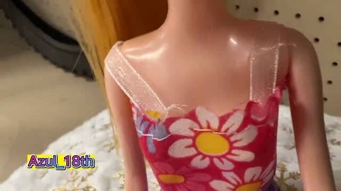 Blonde doll face close-up with blue eyes and pink lips