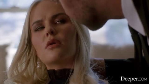 Blonde woman in black lingerie with intense expression during close-up scene