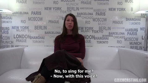 Pavlina in red top, skirt on white couch for Czech Casting