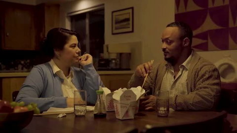 Couple sharing Chinese takeout during intimate dinner date