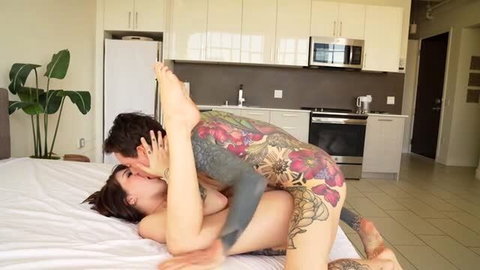 Tattooed trans woman in passionate missionary sex with brunette partner
