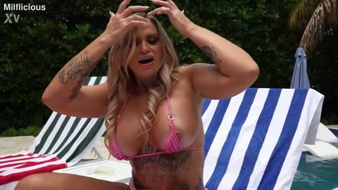 Stephanie Love busty tattooed MILF in pink bikini by pool