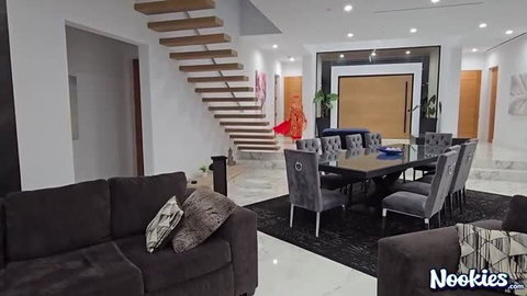 Sasha Pearl in elegant formal dress posing in luxury living room