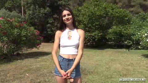 Candie Luciani in white crop top and denim skirt outdoors