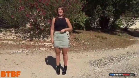 Lexi Doll in tight green mini skirt and black top outdoors