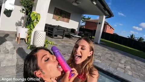 Gina Valentina and Angel Youngs licking double dildo outdoors
