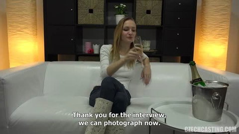 Veronika on casting couch with champagne, white top and jeans