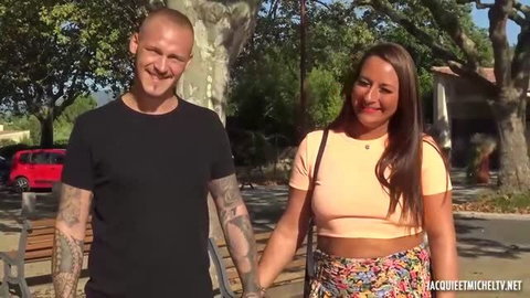 Mila Smart in peach crop top and floral skirt with tattooed man