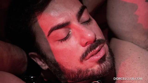 Milan Cheek lying back with closed eyes under red lighting, close-up portrait