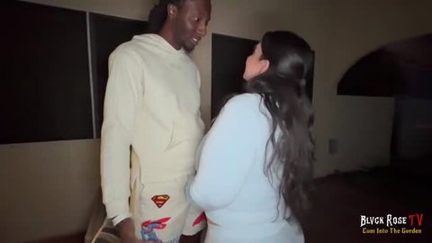 Rose Kush in white outfit standing close to man in cream sweatsuit