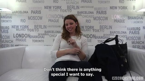 Tereza from Czech Casting sitting on couch in white top