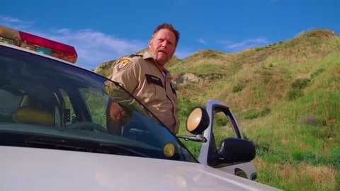 Vanna Bardot as police officer in uniform outdoors