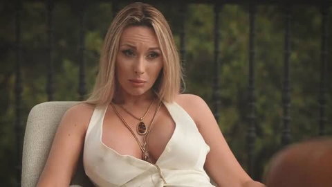 Vanessa Hillz in white dress, seductive expression, sexy cleavage