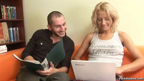 Ellen Lotus and guy studying together on couch in home scene