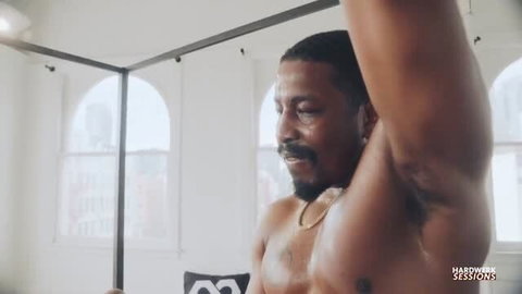 Sweaty shirtless Seth Gamble flexing during HardWerk Sessions shoot