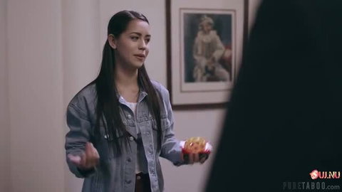 Alina Lopez holding two donuts in denim jacket