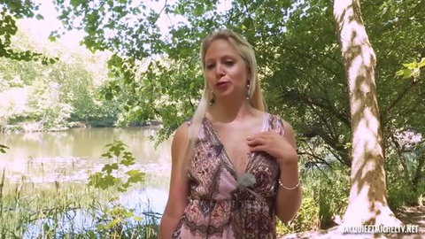 Marie, blonde French MILF in floral dress by pond, outdoor tease