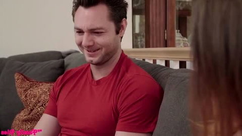 Natasha Nice smiling in red shirt, busty brunette in softcore scene