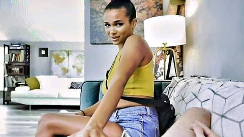 Cute black stepdaughter in yellow tank top and denim shorts smiling teasingly