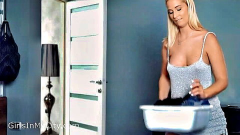 Blonde stepmom in low-cut silver dress holding bowl, cum tease fantasy
