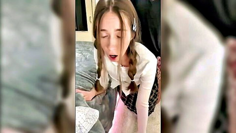 Skinny schoolgirl with pigtails deepthroats and receives cum on couch