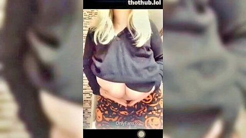 Blonde bombshell exposing massive tits and juicy ass in Halloween pumpkin panties