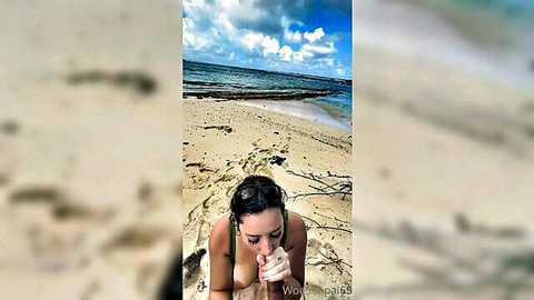 Busty babe flashes huge tits on beach, teasing with finger near mouth