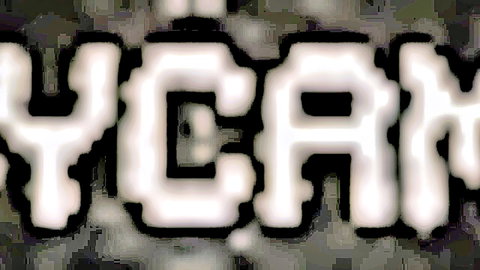 YCAM watermark logo in pixelated white text on dark background
